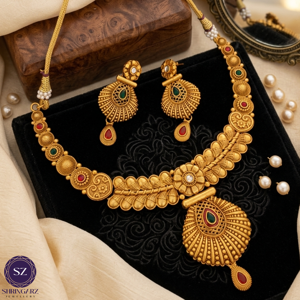 Shringarz Antique Matte Gold-Plated Nakshi Choker Set with Traditional Fan-Motif Pendant and Ruby-Emerald Accents