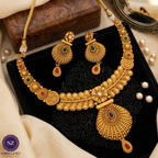 Shringarz Antique Matte Gold-Plated Nakshi Choker Set with Traditional Fan-Motif Pendant and Ruby-Emerald Accents