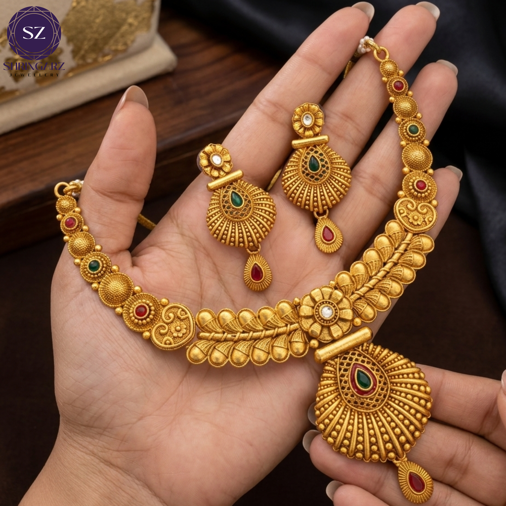 Shringarz Antique Matte Gold-Plated Nakshi Choker Set with Traditional Fan-Motif Pendant and Ruby-Emerald Accents