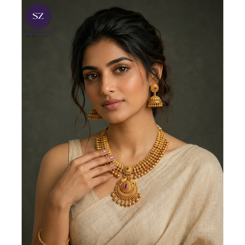 Shringarz Antique Gold Matte Temple Jewelry Set with Peacock Pendant & Jhumkas